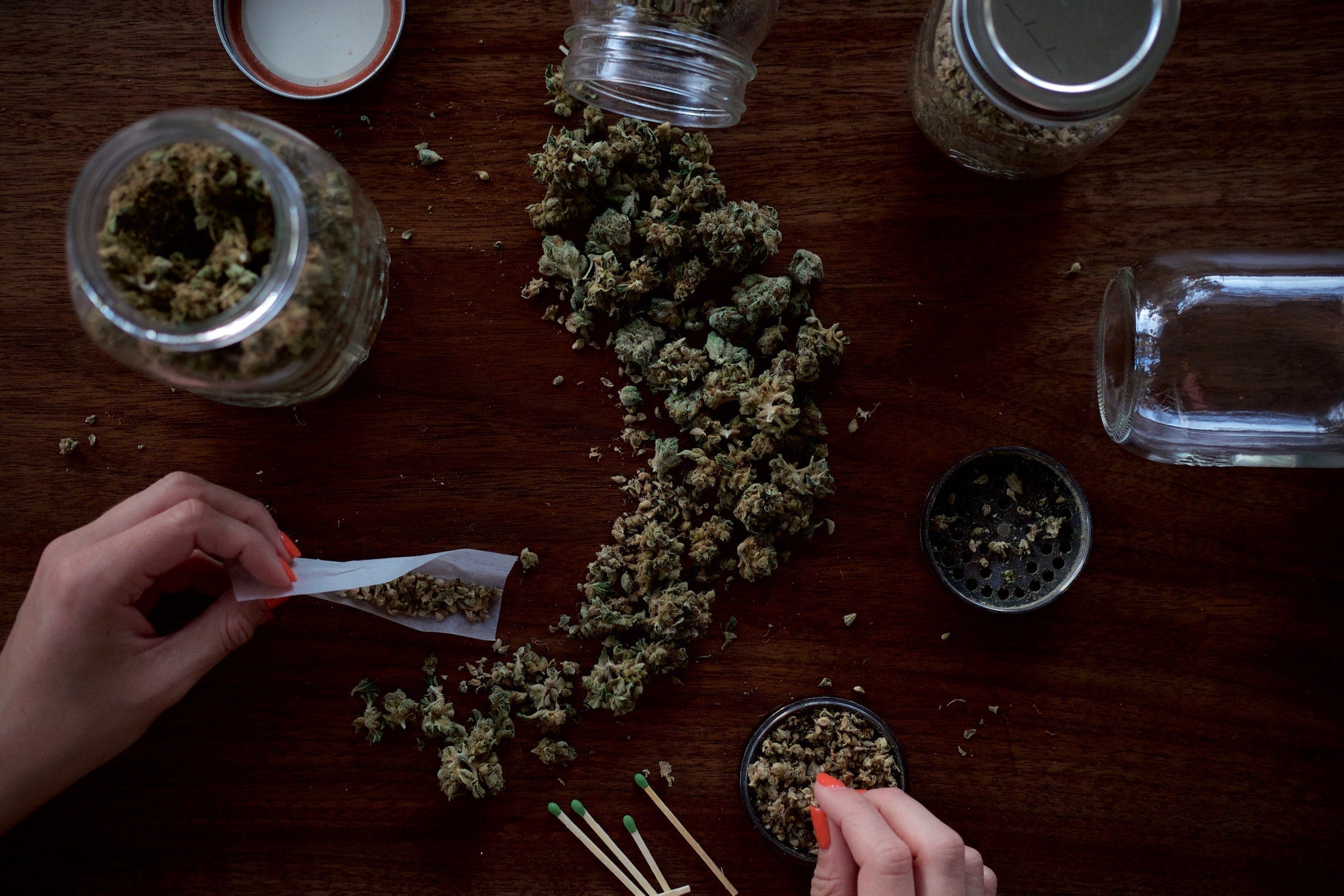 Woman rolling joint with grinder - Shell Shock