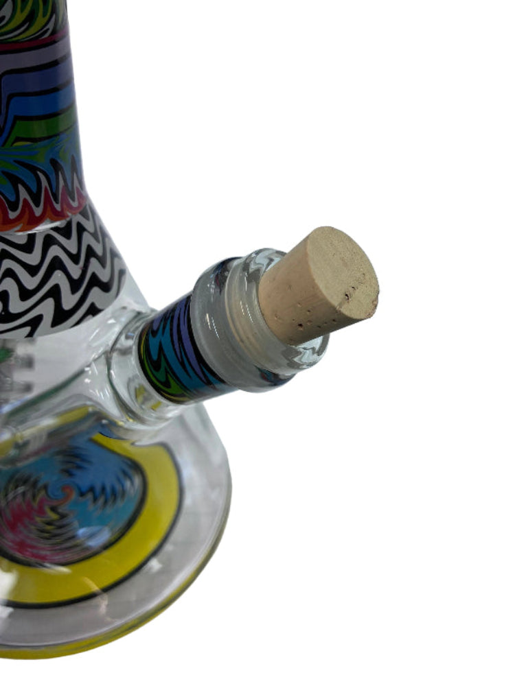 Close-up of a glass bottle with colorful design and cork stopper on a white background
