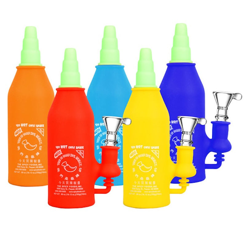 Colorful spray bottles with nozzles on a white background