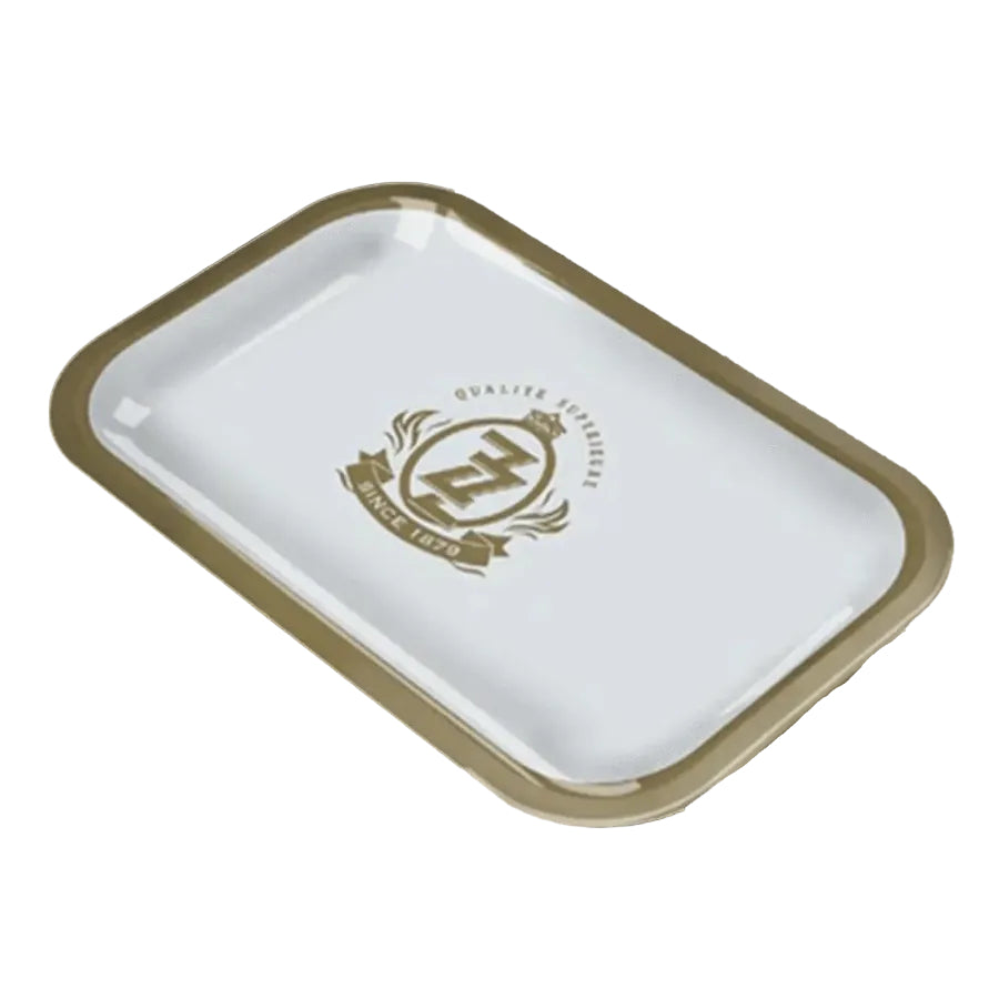 A small white and gold zig zag rolling tray on a white background