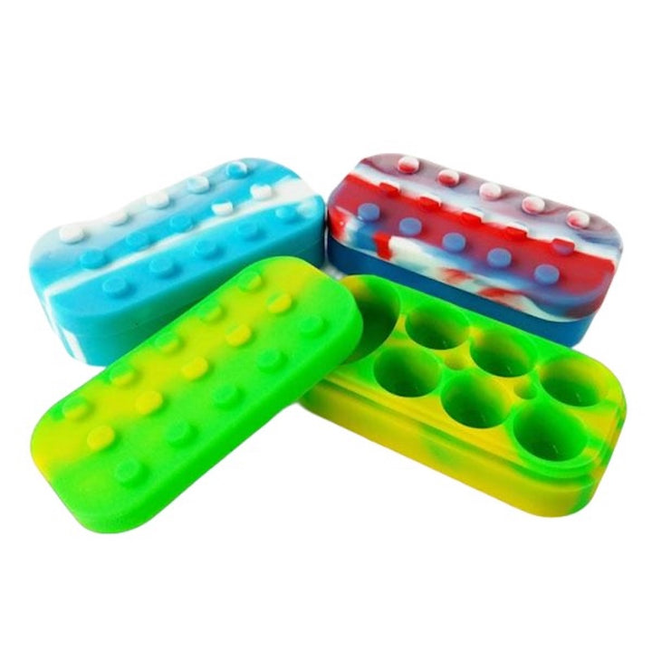 Colourful LEGO-like silicone concentrate holders on a white background
