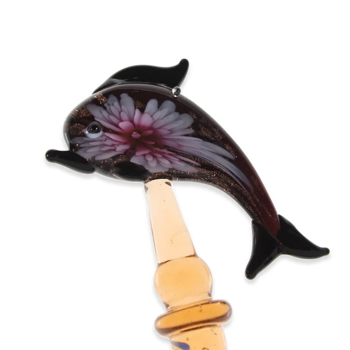 Glass sculpture of a dolphin with a white background