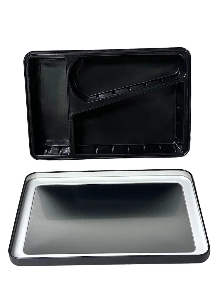 Two black plastic trays on a white surface