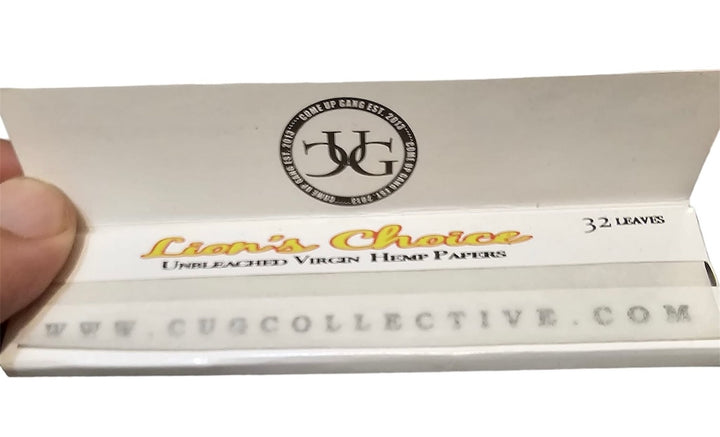 Cigarette rolling paper pack with 'Lion's Choice' branding and a visible hand holding it.