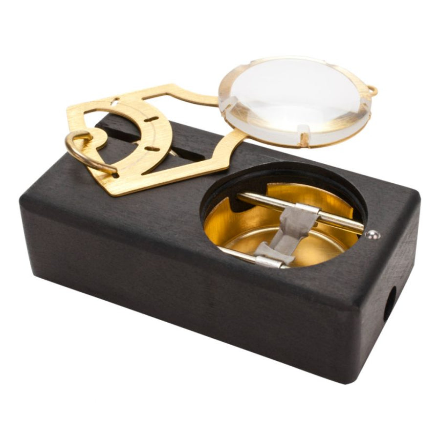 a small black and gold concentrate kit on a white background