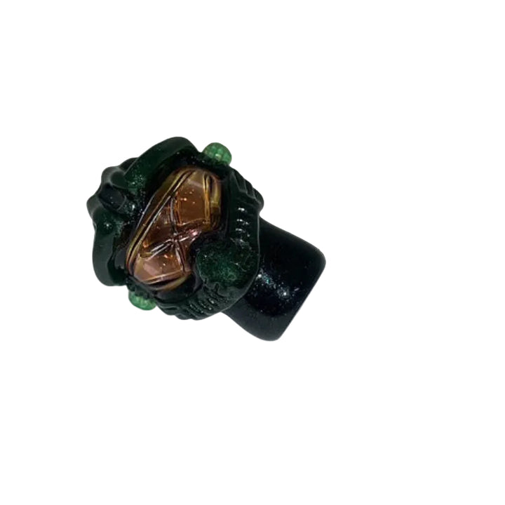 Ring with green and gold design on a white background