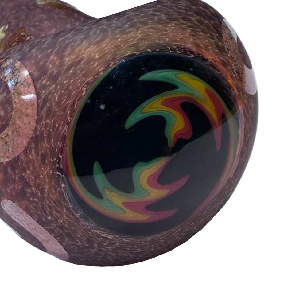 Close-up of a glass pipe with colorful swirl design on a white background