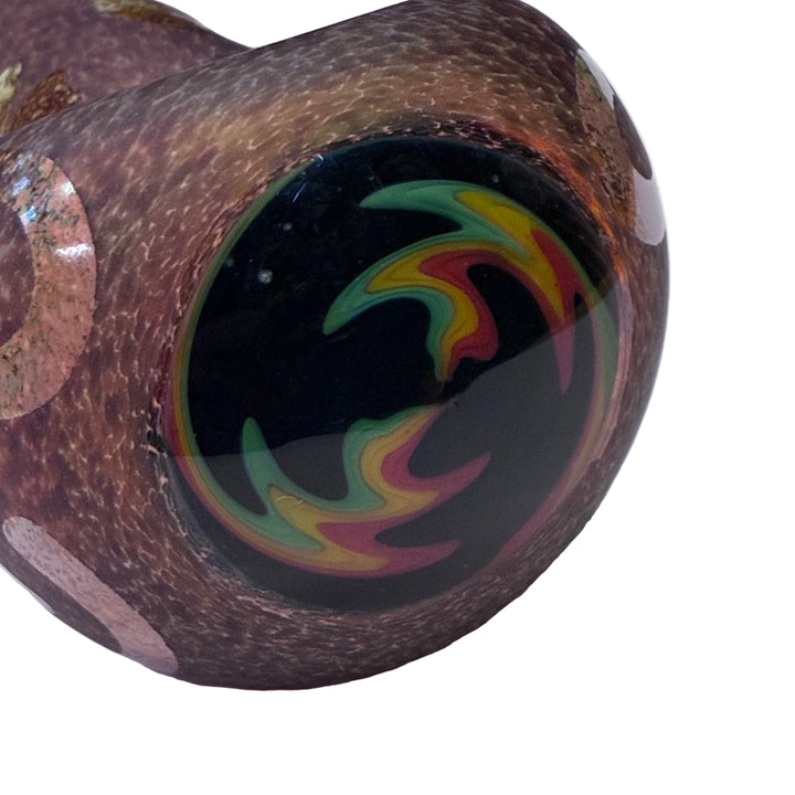 Close-up of a glass pipe with colorful swirl design on a white background