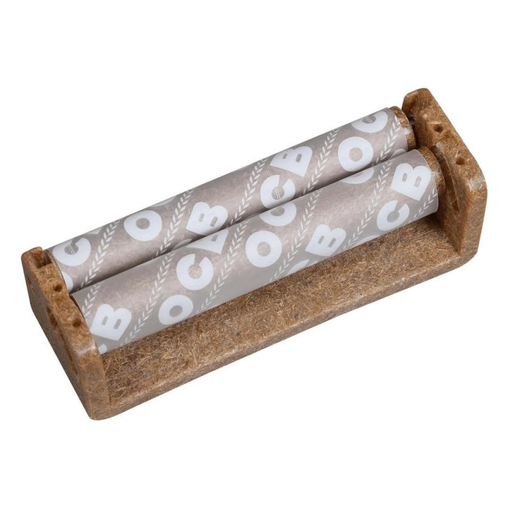 A miniature dollhouse-scale brown plastic rolling tray holding two rolled papers with a white 'CB' leaf pattern, shown on a plain white background.