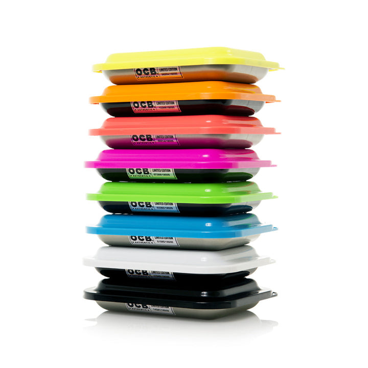 an array of colourful plastic rolling try lids with the letters OCB on a white background