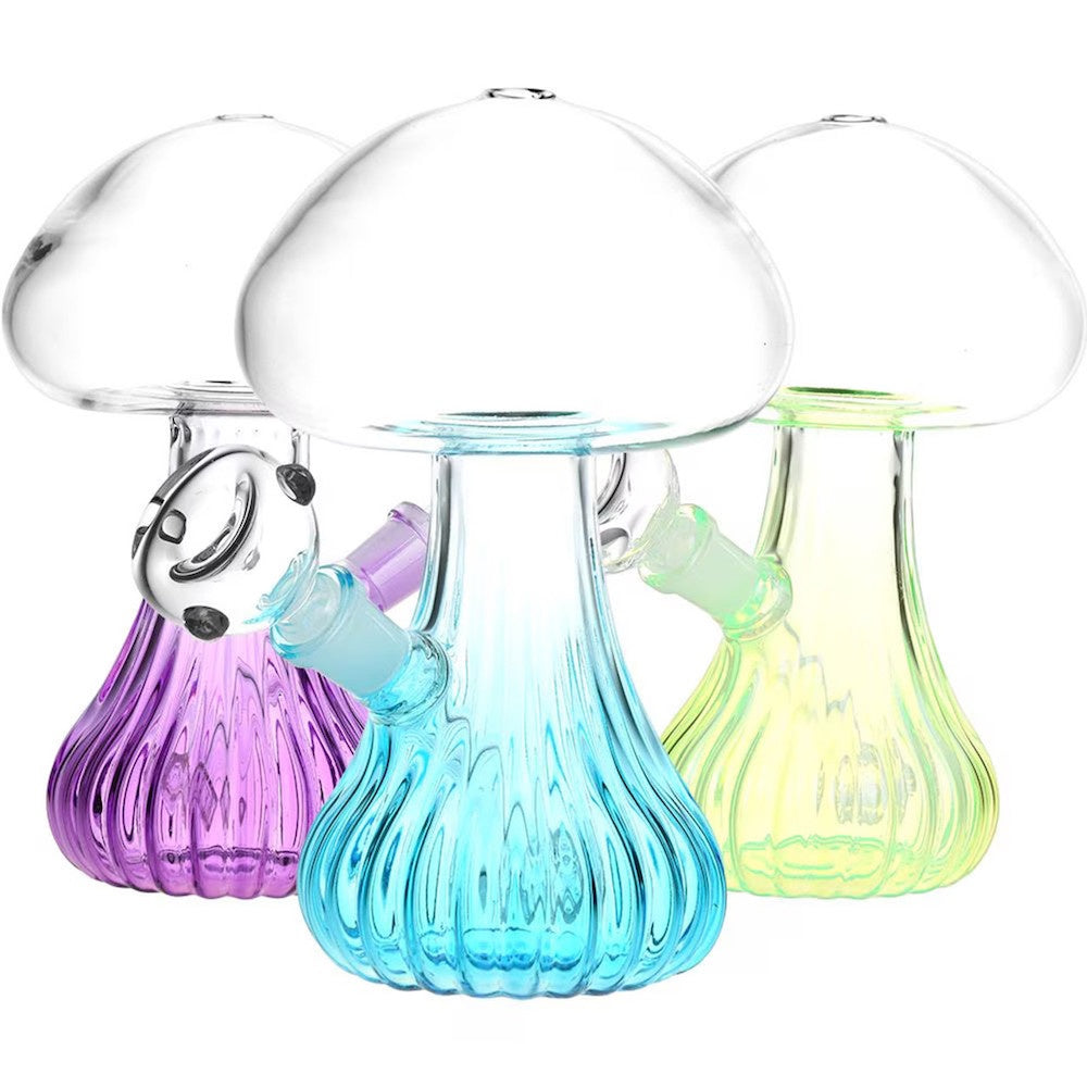 Three colorful glass mushroom-shaped bottles on a white background