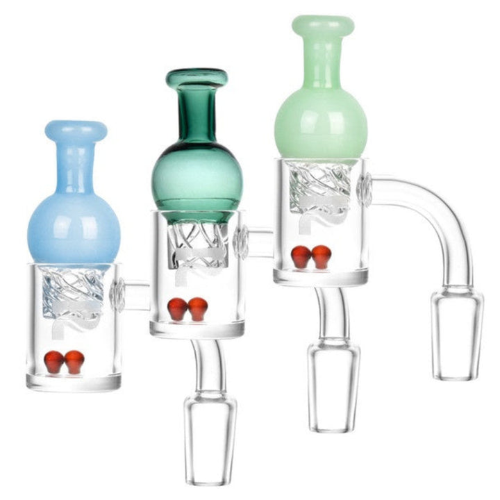 Quartz banger with terp pearls and helix carb cap on white backround