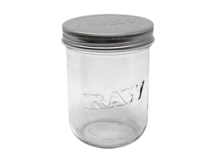 Clear glass jar with a metal lid on a white background