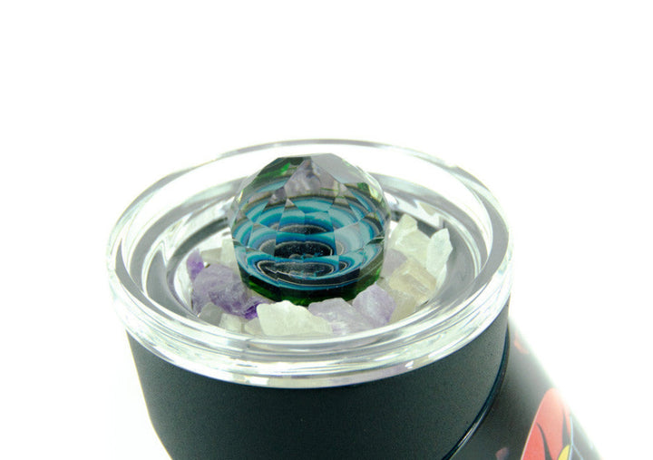 Glass smoking accessory with colorful interior on a white background