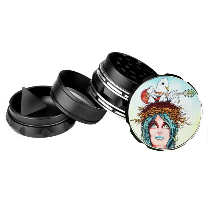 Black metal grinder with a colorful design on one of its sides, featuring a face with blue hair and a bird on a white background.