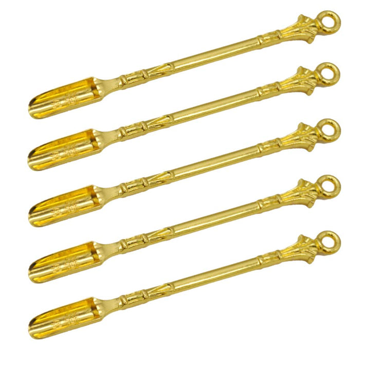small golden spoons on a white background