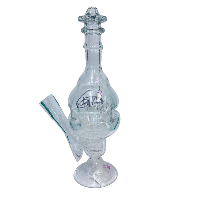 Clear glass fab egg water pipe on a white surface with green background