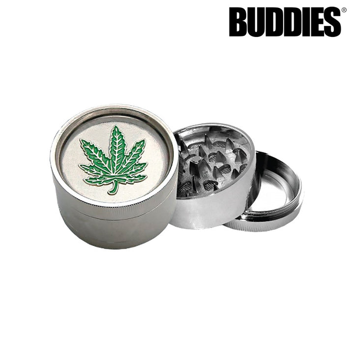 Metal grinder with cannabis leaf design on a white background, featuring the brand 'Buddies'.
