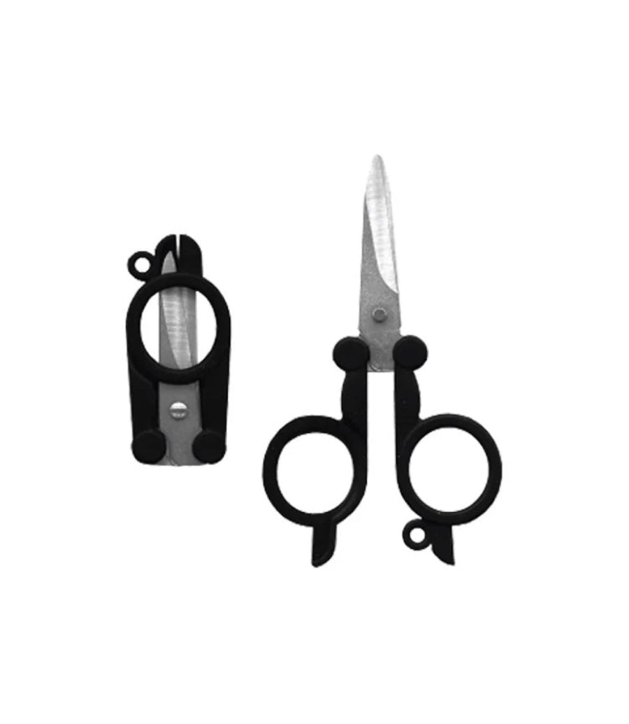 Scissors with black handles and a sharpener on a white background