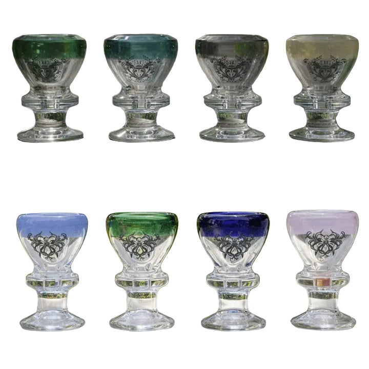 Set of six glass goblets with colored bottoms on a white background.