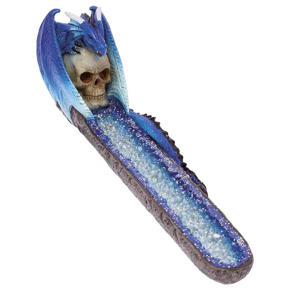 Decorative incense burner with a skull inside a blue dragon-like creature on a white background