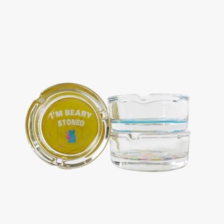 Glass ashtray with yellow lid featuring 'I'm Beary Stoned' text on a white background