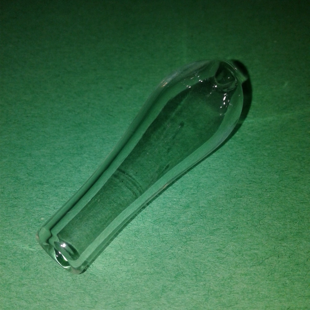 Clear glass mouth-piece on a green background