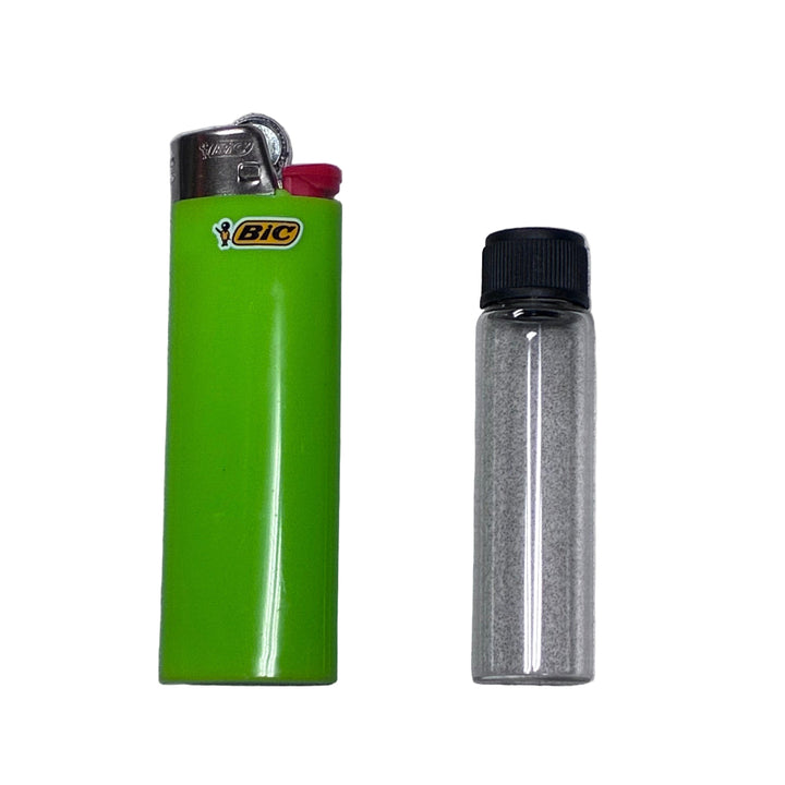 Green BIC lighter and a glass vial with black lid on a gray background