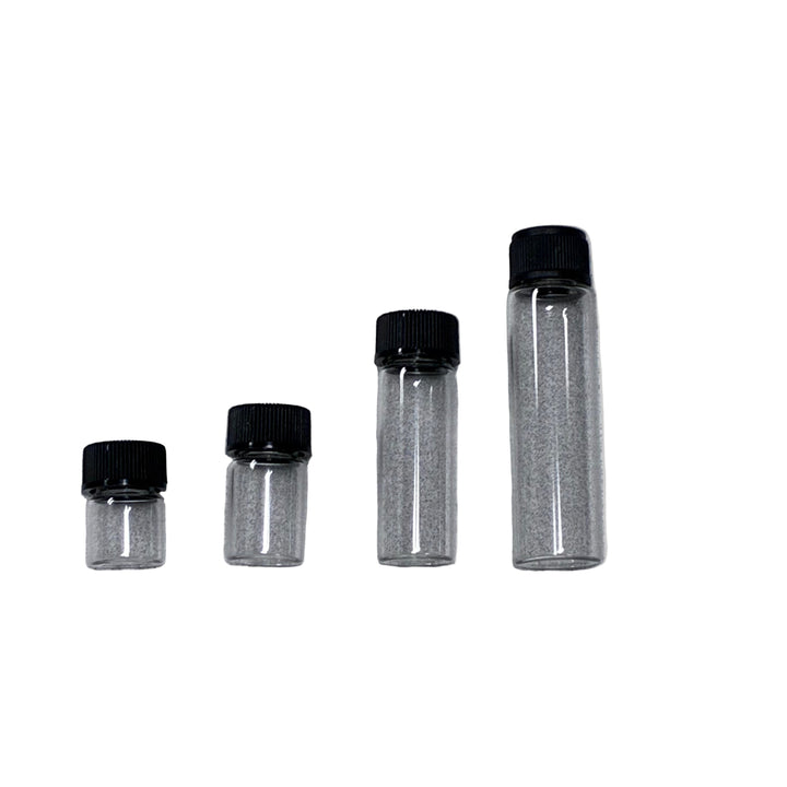 Four clear glass vials with black lids on a gray background