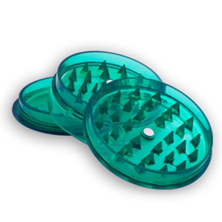 Green transparent herb grinder on a white background