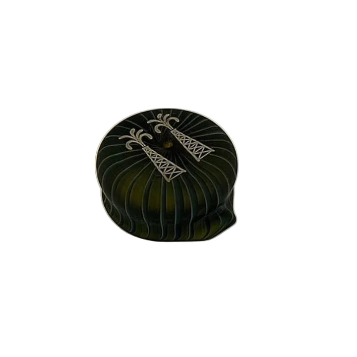 Decorative black container with white design on a beige background