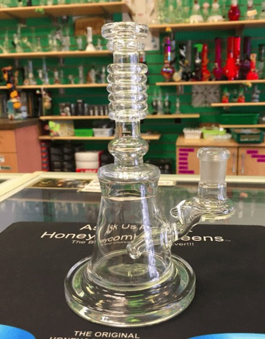 Glass smoking device on a counter with a store shelf in the background