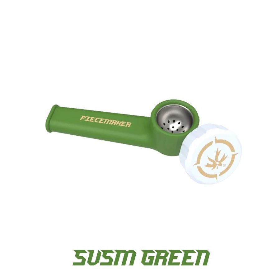 A green Piecemaker smoking pipe with its white and gold branded cap placed beside it on a white background.