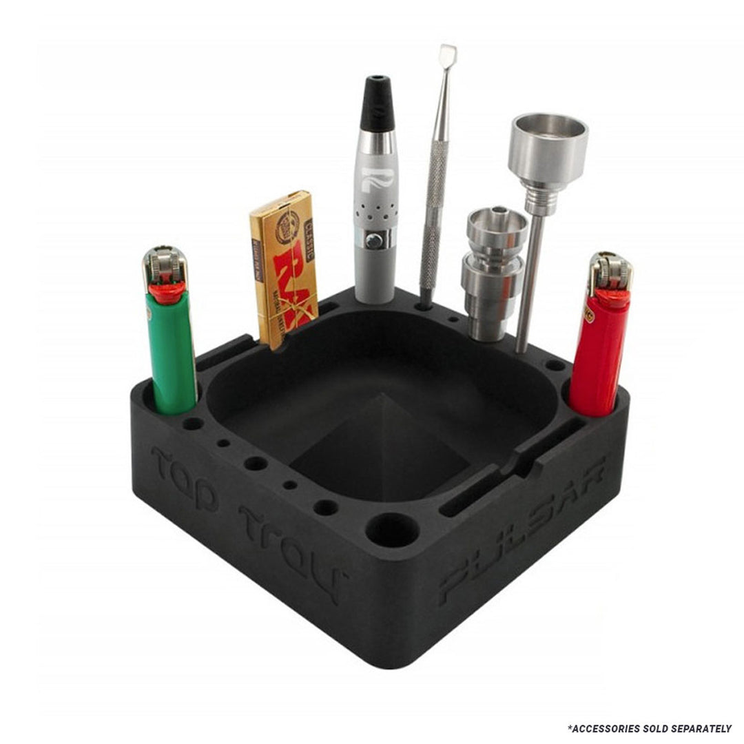 Black silicone ashtray with smoking accessories on a white background