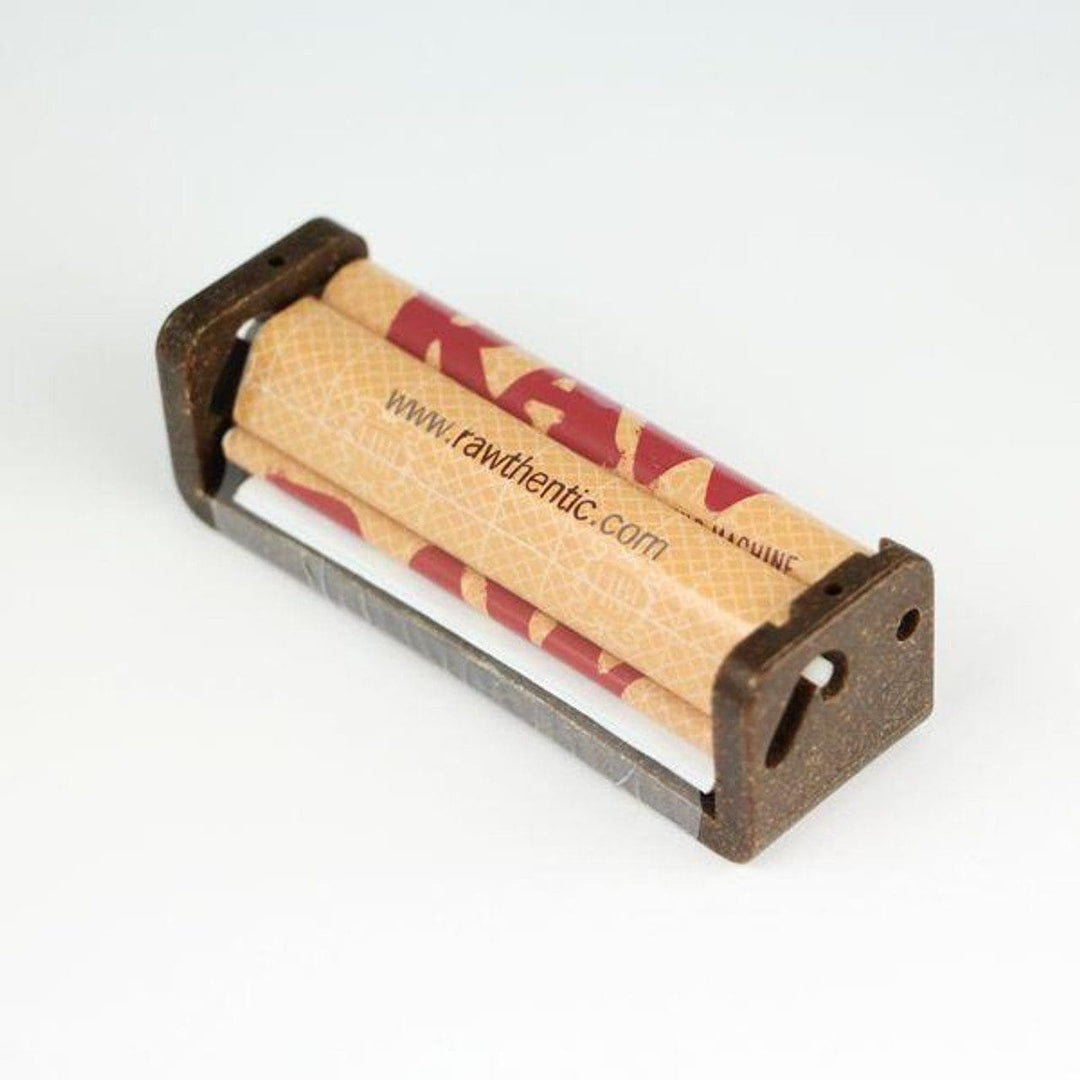 A small metal rolling tray holding two rolled joints with a tan paper wrapper printed with red and black graphics and the text 'www.rawthentic.