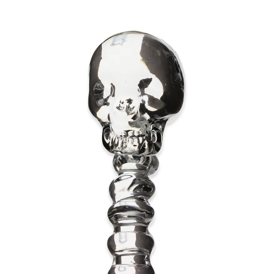 Silver skull-shaped object on a white background