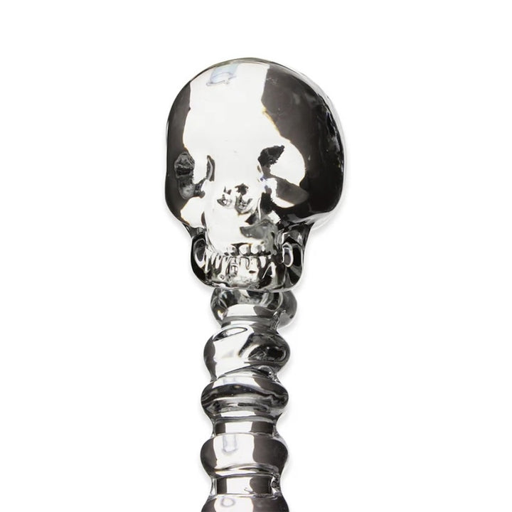 Silver skull-shaped object on a white background