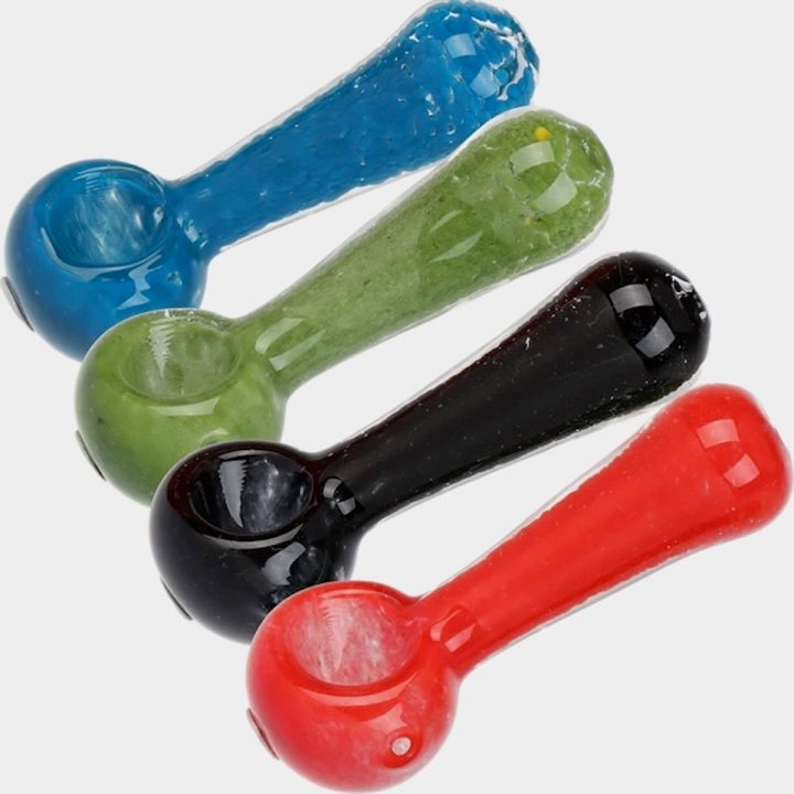 Four colorful glass smoking pipes on a white background