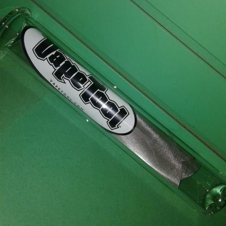 Close-up of a green tool with a visible brand logo on a green background