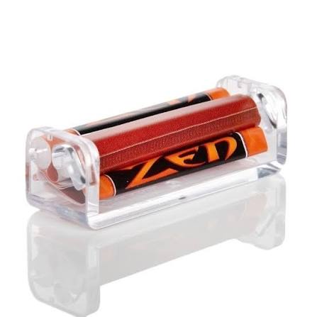 A clear acrylic battery holder containing two orange and black ZEN brand batteries, shown on a reflective white surface.